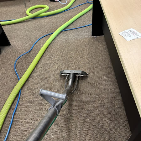 Technician performing low moisture encapsulation carpet cleaning in a pennsylvania office lobby